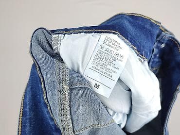 spodnie dziury: Jeansy damskie, rozmiar M — 4